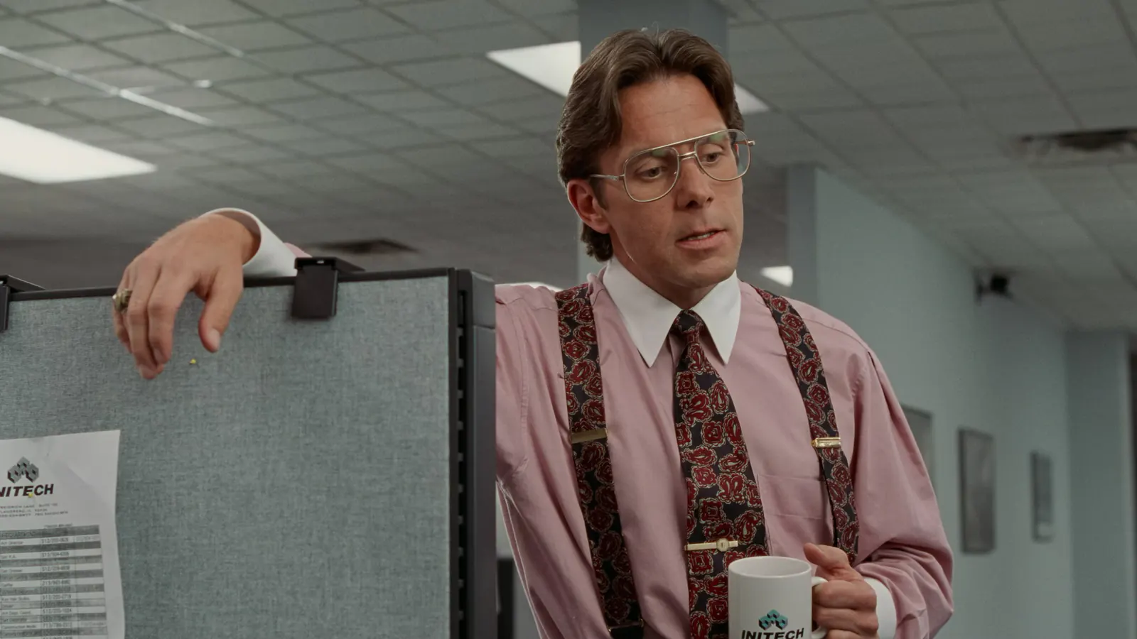 An office manager leaning over a cubicle in Office Space
